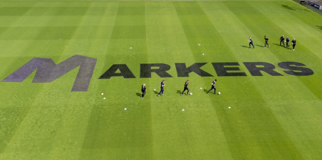 Markers signage on the pitch at Bloomfield Road, home of Blackpool FC, in order to promote the National Football Museum, UK